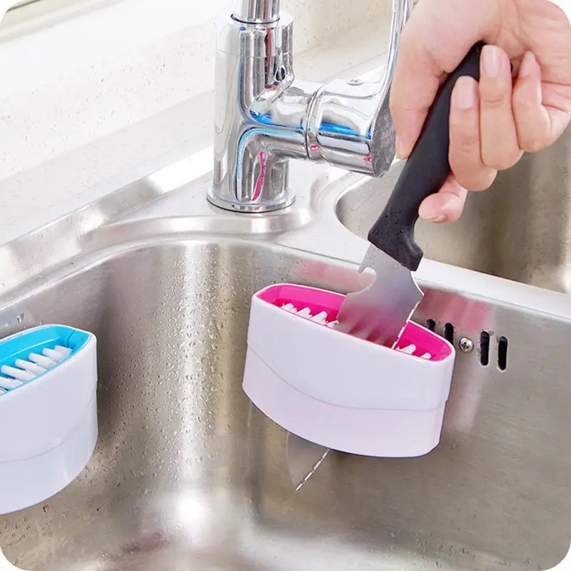 Pink Cutlery brush cleaner cleaning a knife in the sink. Different colors available.