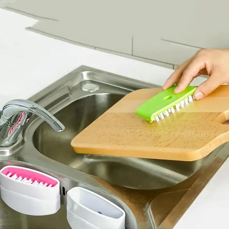 Cutlery brush cleaner cleaning a cutting board in the sink. Different colors available.